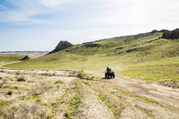 A family riding an ATV on a trail.