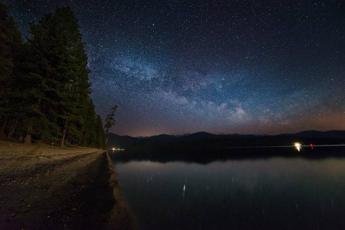 The Milky Way rises over a campground.