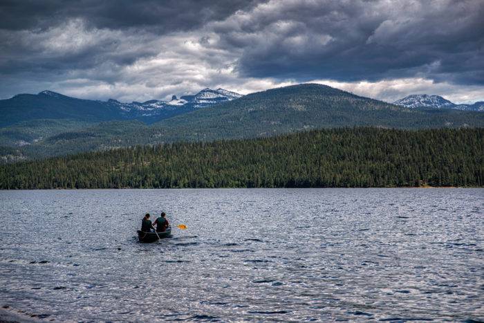 Two people in a canoe on a lake.