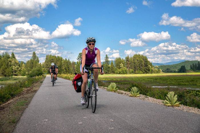 Cyclists riding next to a lake