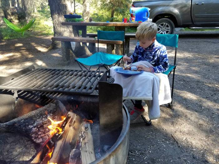 Eating breakfast next to the fire on a sunny Idaho morning.