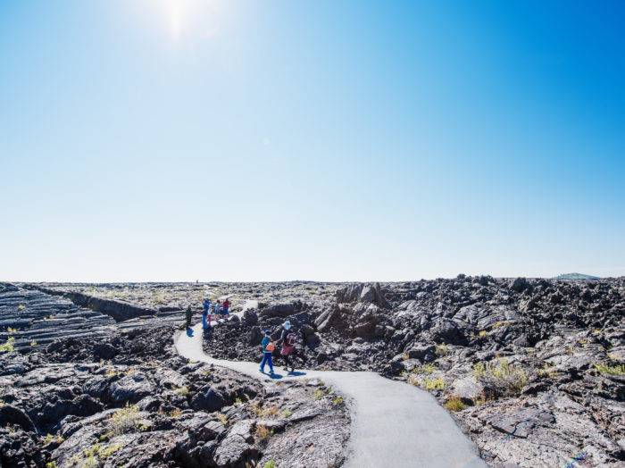 Exploring Craters of the Moon trails. Photo Credit: Idaho Tourism