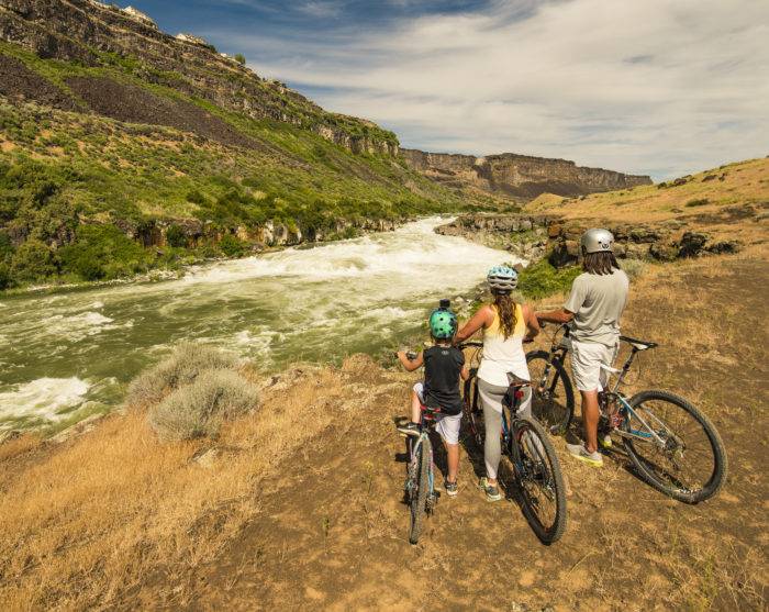 mountain bikers near waterfall
