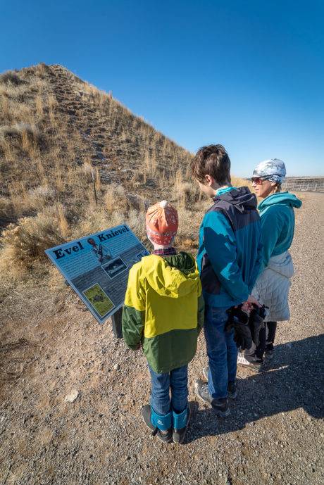 family reading educational sign
