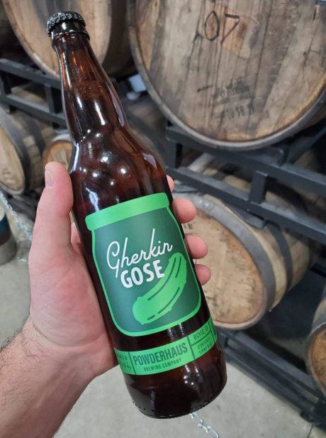 person holding beer bottle