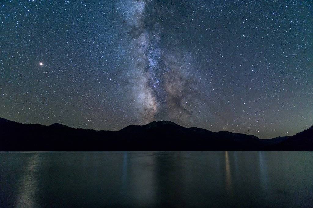 A starry night of the Milky Way, Mars, Saturn and Jupiter over Alturas Lake in Idaho