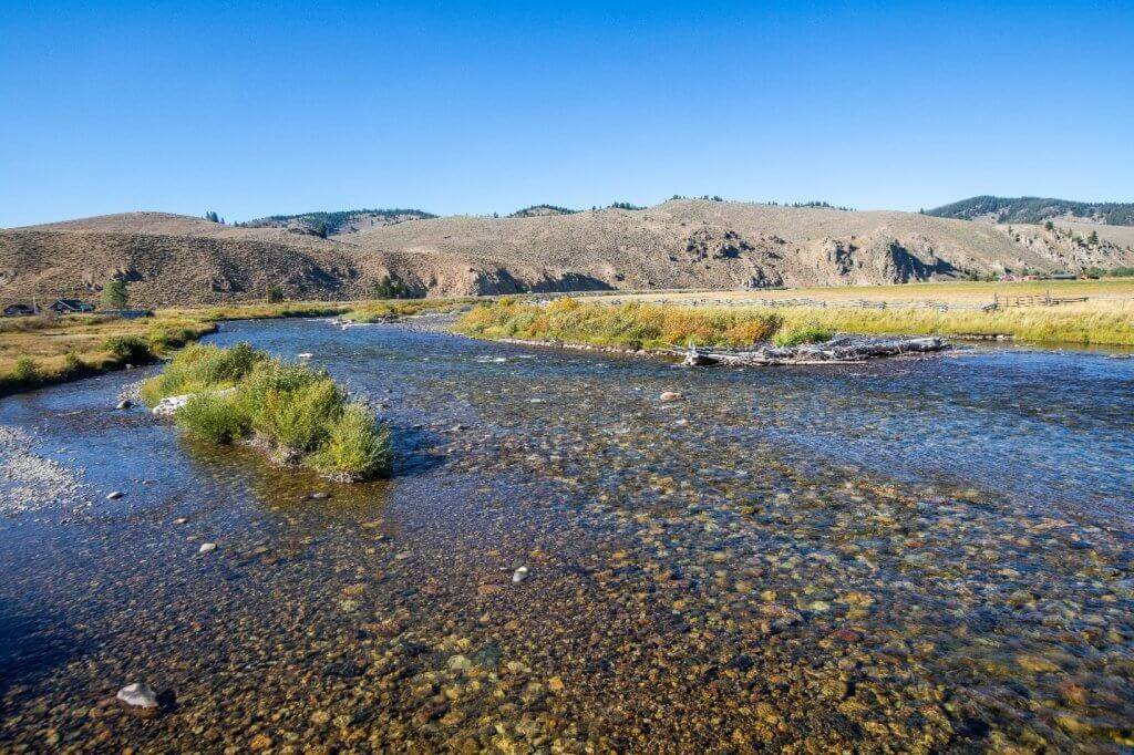 scenic view of salmon river with mountains in background