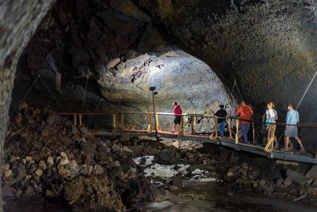people waking on trail inside Shoshone Ice Caves