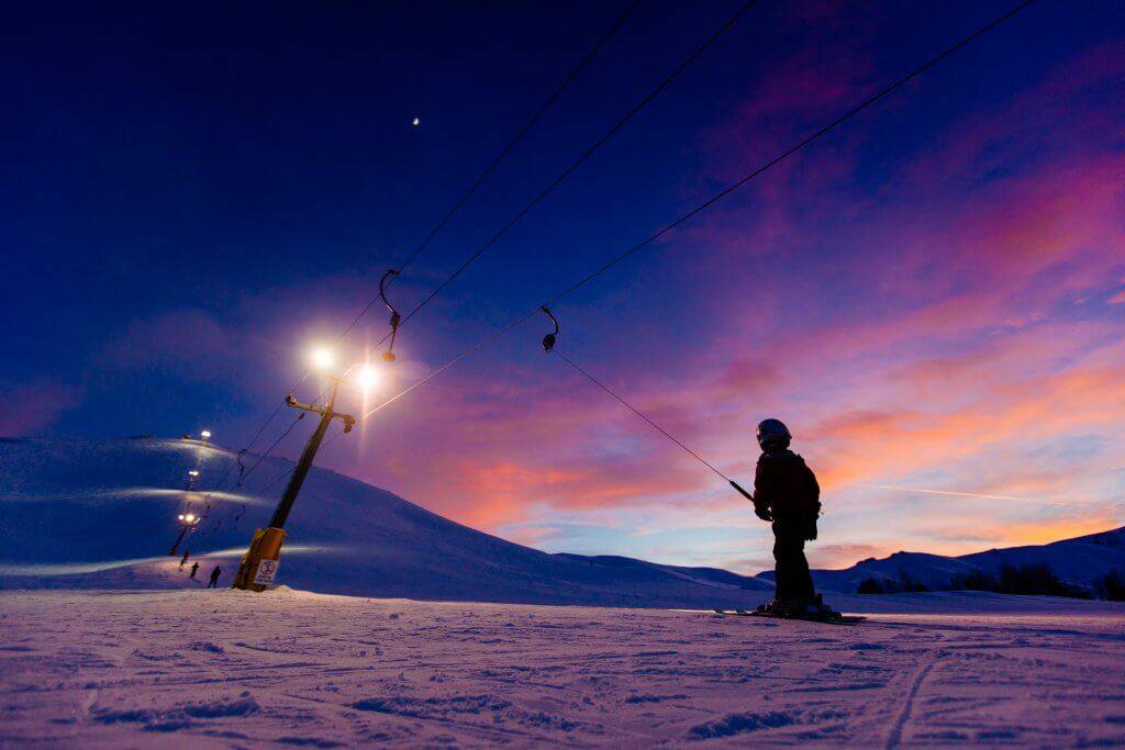 child on ski pull at sunset