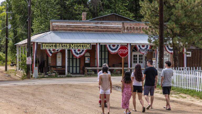 a group of people walking toward the Boise Basin Museum