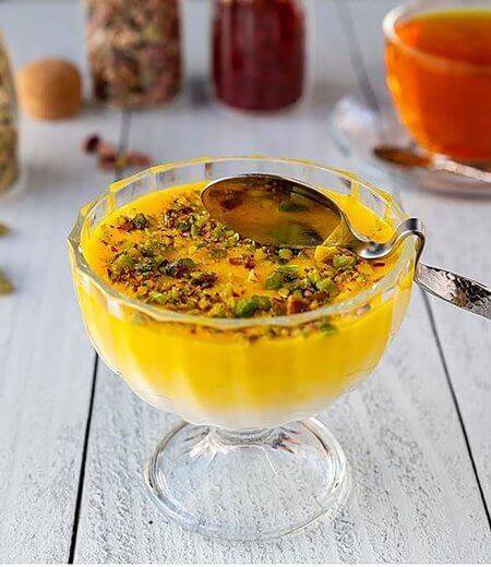 glass dish with yellow saffron pudding