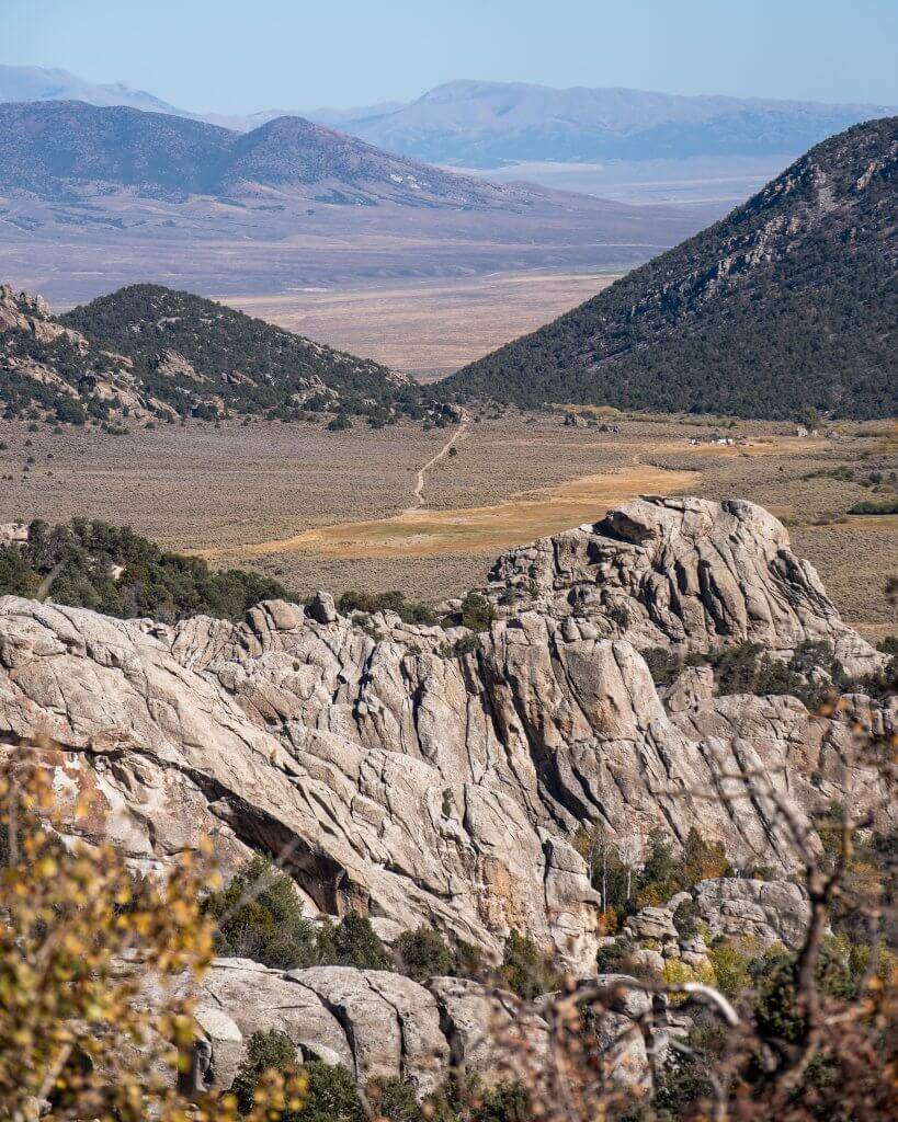 wide view of dirt road down in a rocky valley