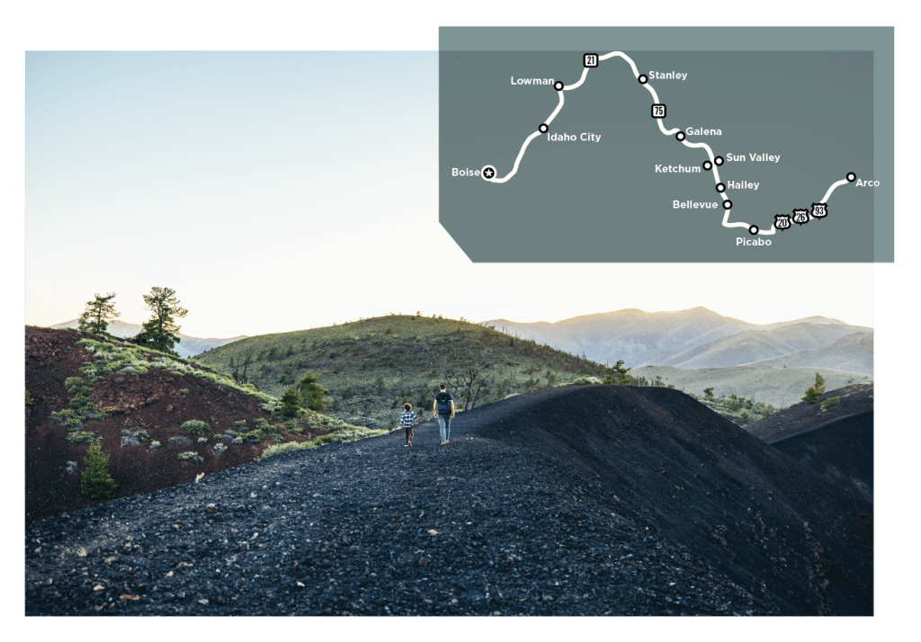 An adult and child walking in Craters of the Moon National Monument.