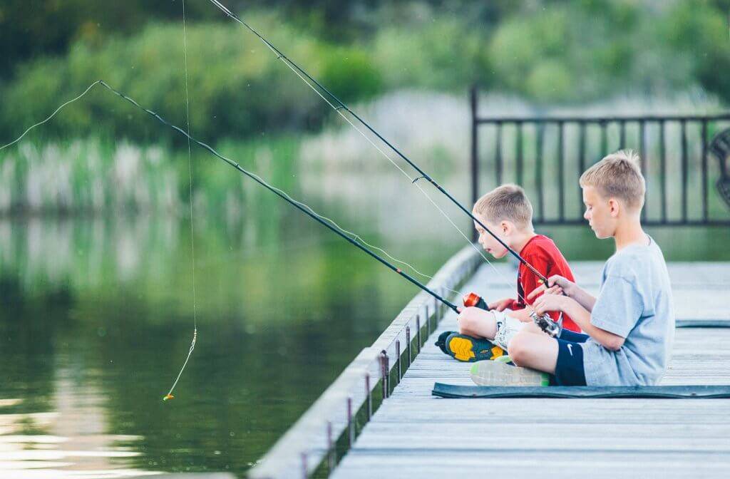 Two kids fishing on a dock at Anderson Ranch Reservoir.