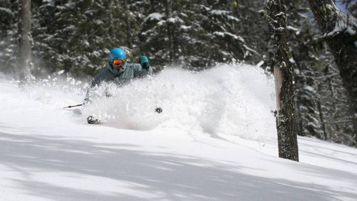 Skier charges through powder along the treeline at Soldier Mountain.