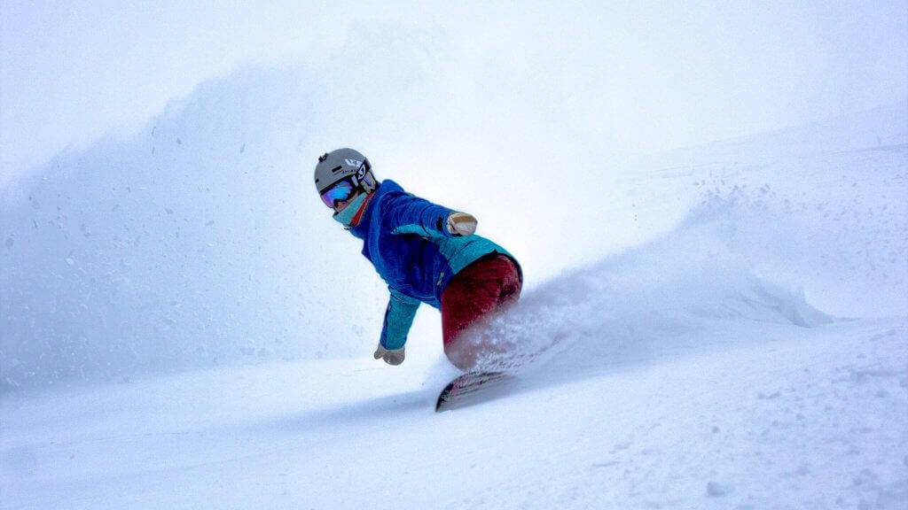 A person snowboarding in outdoor gear at Magic Peak.