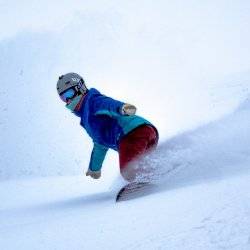 A person snowboarding in outdoor gear at Magic Peak.