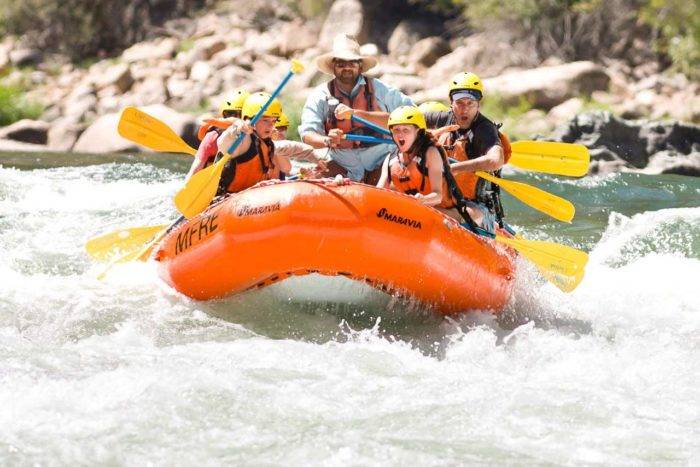 Kids rafting on a river.