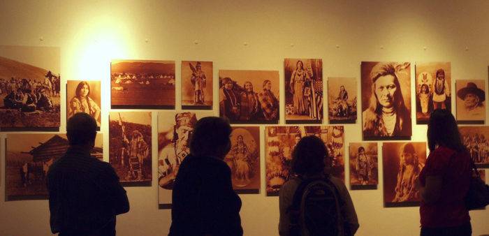 People viewing a Nez Perce photo display