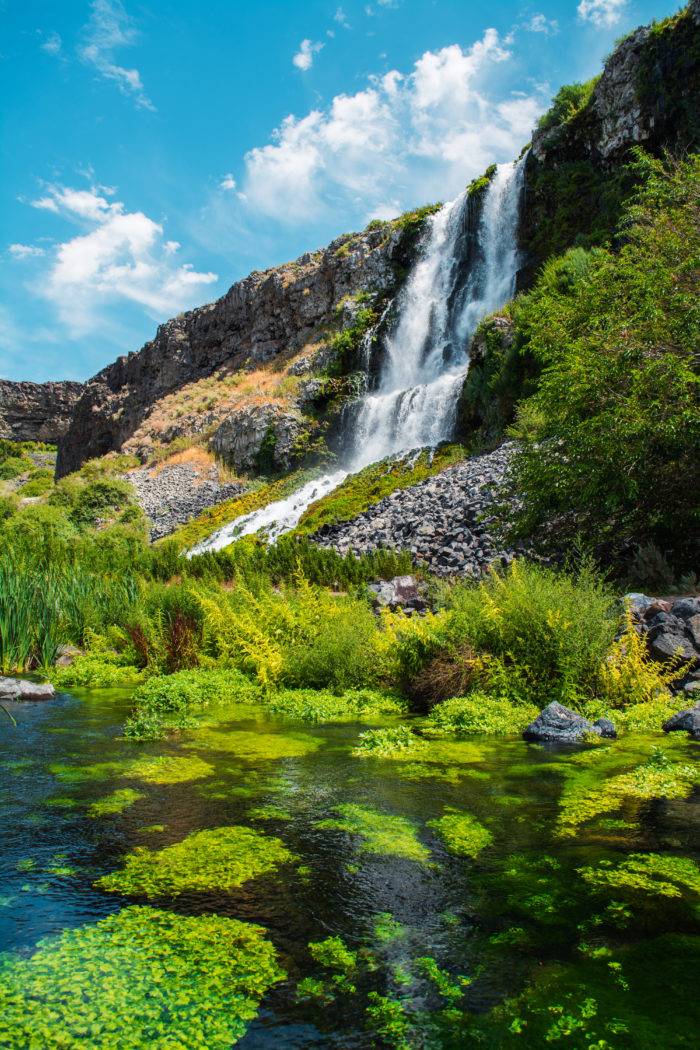 A waterfall flowing into a body of water below.