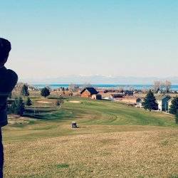 A golfer finishing his swing.