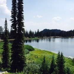 A scenic view of a lake on top of a mountain.