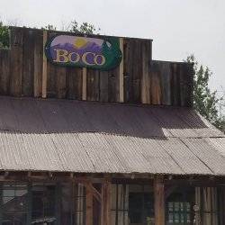 A historical wooden building with a sign that says Boco at the Idaho City Historical Area.