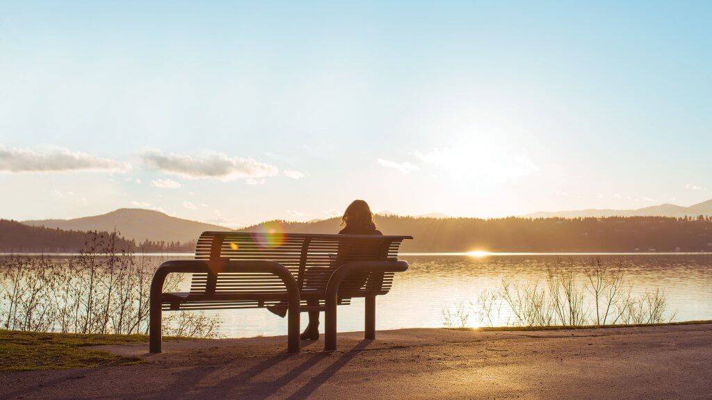 Woman on bench at Coeur d'Alene Parkway State Park