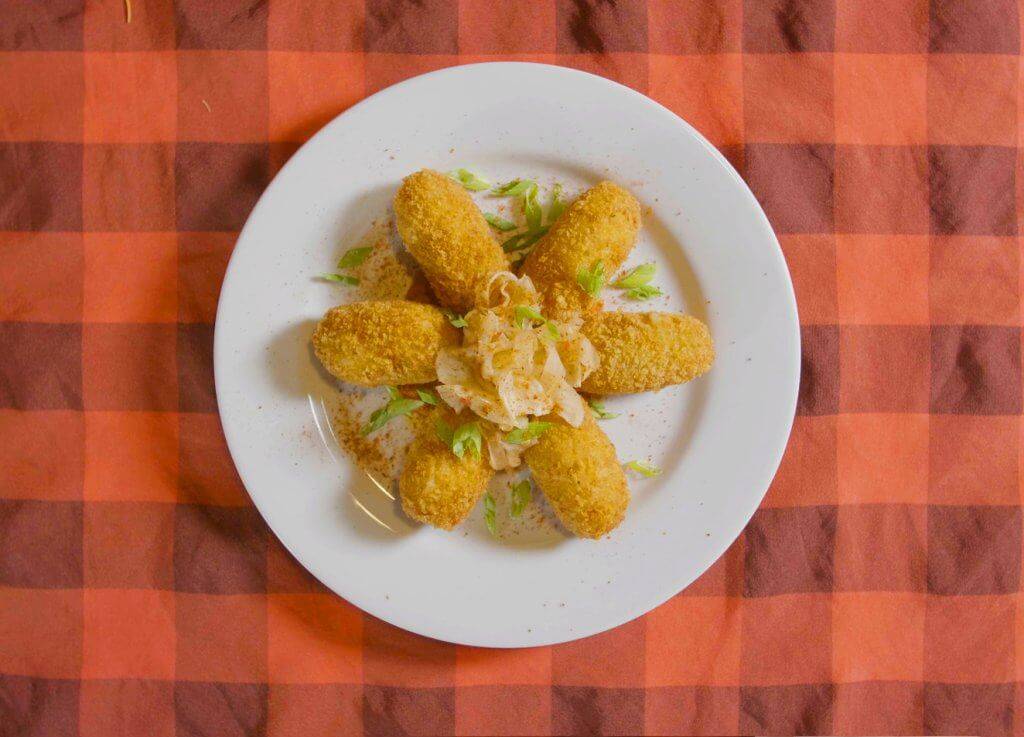 An overhead shot of croquetas on a round plate from Leku Ona.