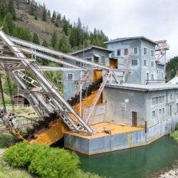 A historic building with mining equipment at Custer Historic Mining Town.