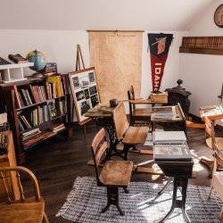 A room filled with historical artifacts at the Hughes House Museum.