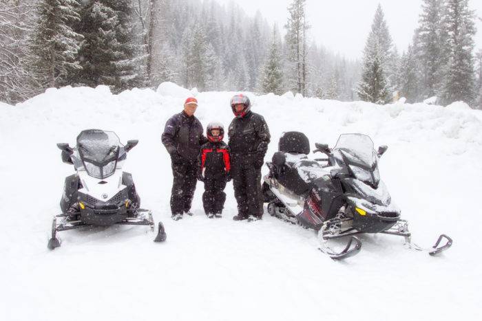 Snowmobiles and riders at the ready.