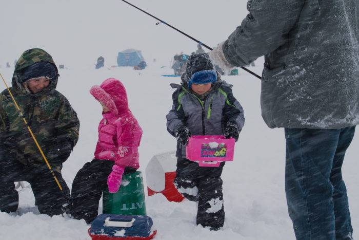 Two kids getting ready to fish at the Idaho Youth Outdoors: 7th Annual Youth Ice Fishing Day.