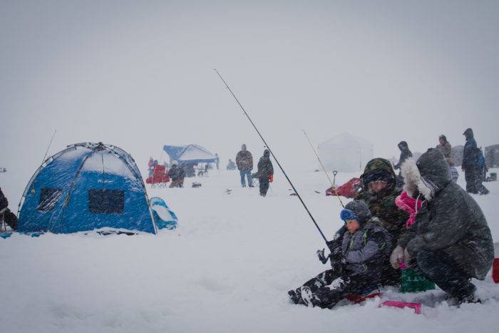 A family hoping to catch some Perch at the Idaho Youth Outdoors: 7th Annual Youth Ice Fishing Day.