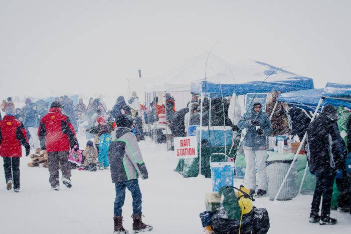 People grabbing supplies at the Idaho Youth Outdoors: 7th Annual Youth Ice Fishing Day.