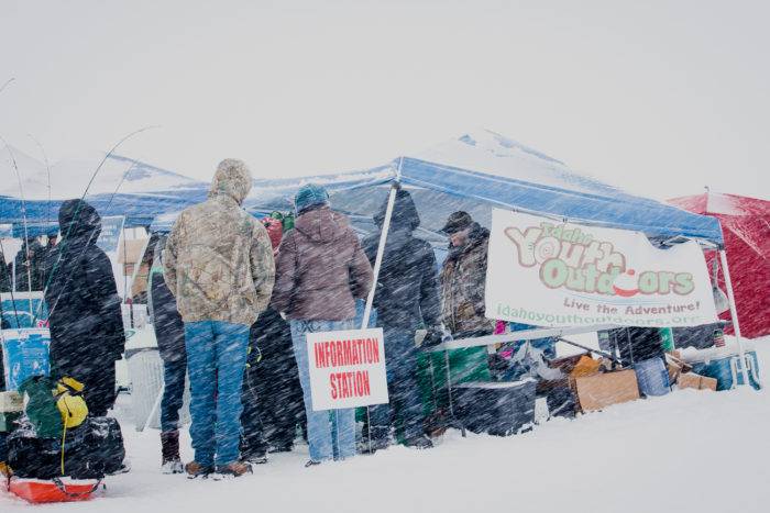 Youth getting bait from the supply station at the Idaho Youth Outdoors: 7th Annual Youth Ice Fishing Day.