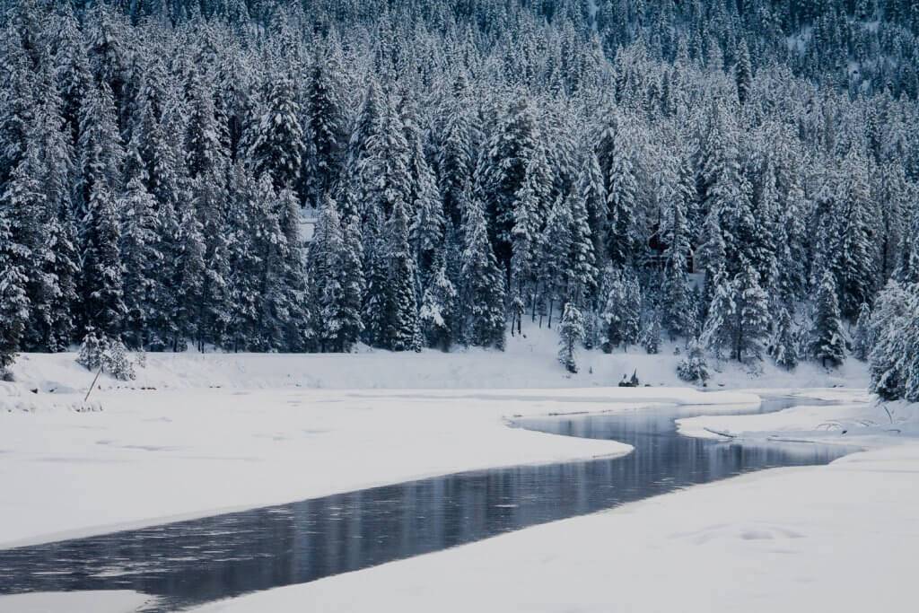 A river in the winter covered in snow.