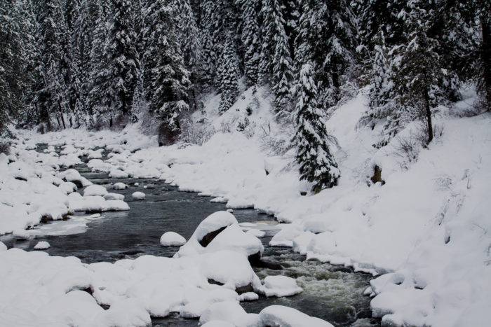 The Payette River with its banks covered in snow, along the Payette River Scenic Byway.