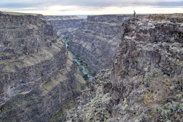 A man looking into a canyon.