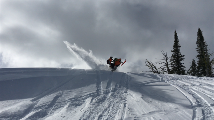 A snowmobiler exploring backcountry.