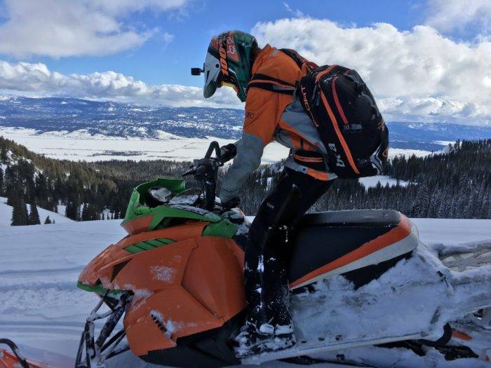 A snowmobiler exploring backcountry.