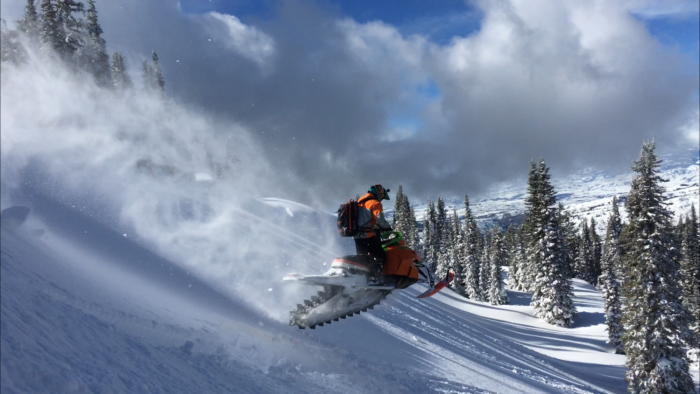 A snowmobiler exploring backcountry.