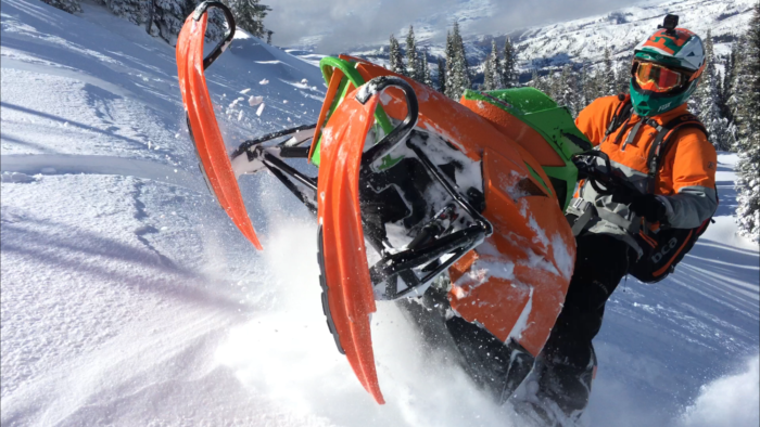 A snowmobiler exploring backcountry.