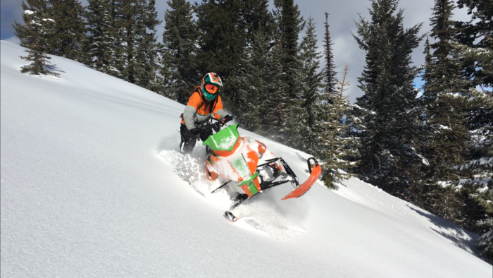 A snowmobiler exploring backcountry.