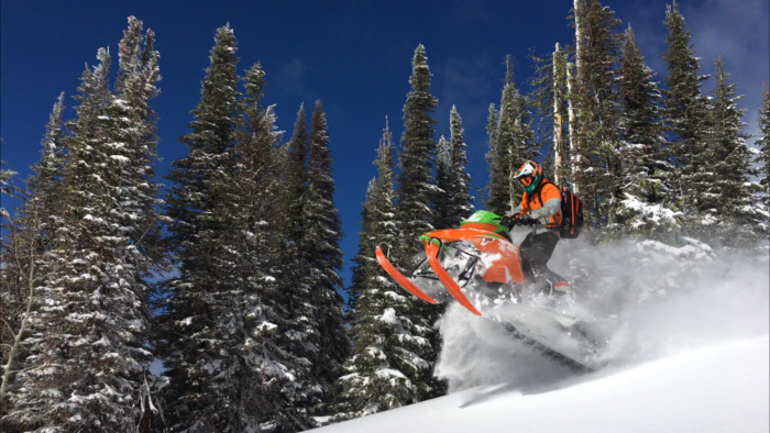 A snowmobiler exploring backcountry.