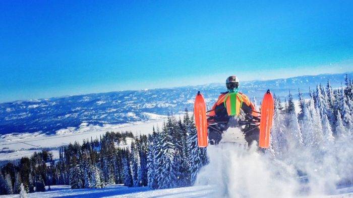 A snowmobiler exploring backcountry.