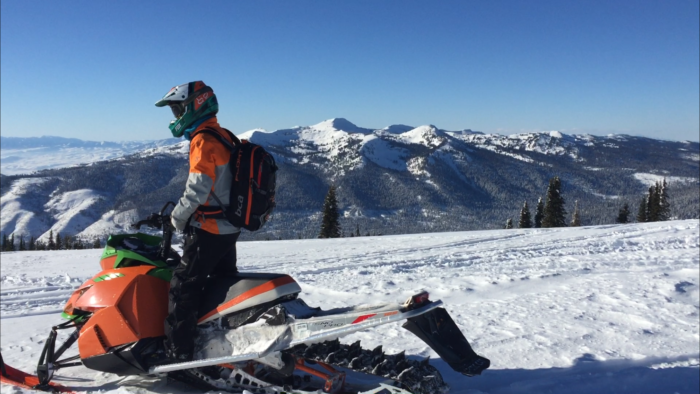 A snowmobiler exploring backcountry.