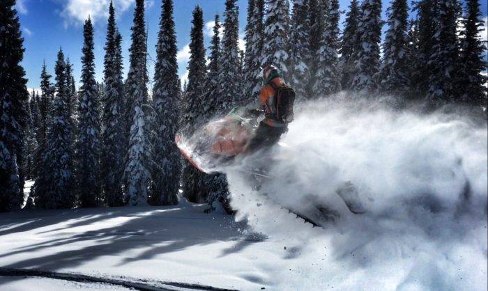 A snowmobiler exploring backcountry.