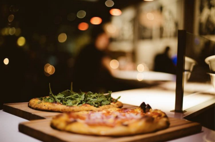 A picture of two pizzas on a table.