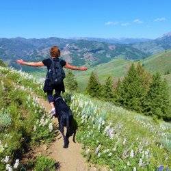 Woman hiking with dog.